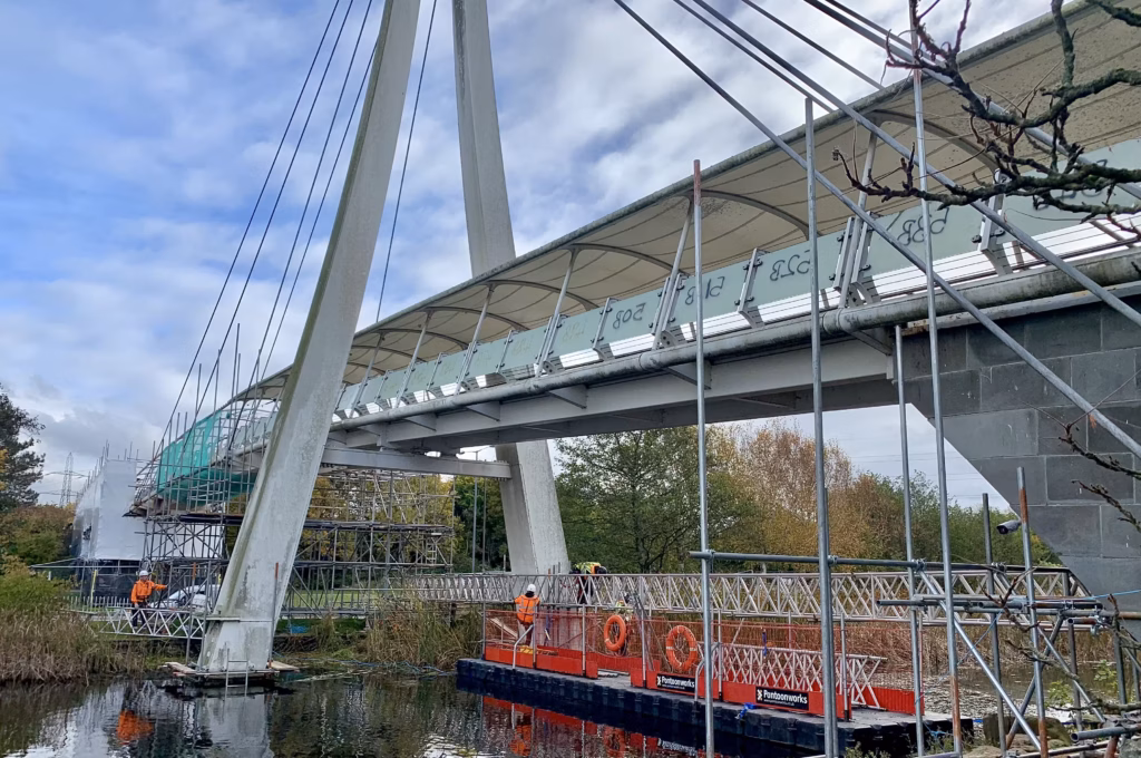 removing industrial coating via pontoon under a steel bridge